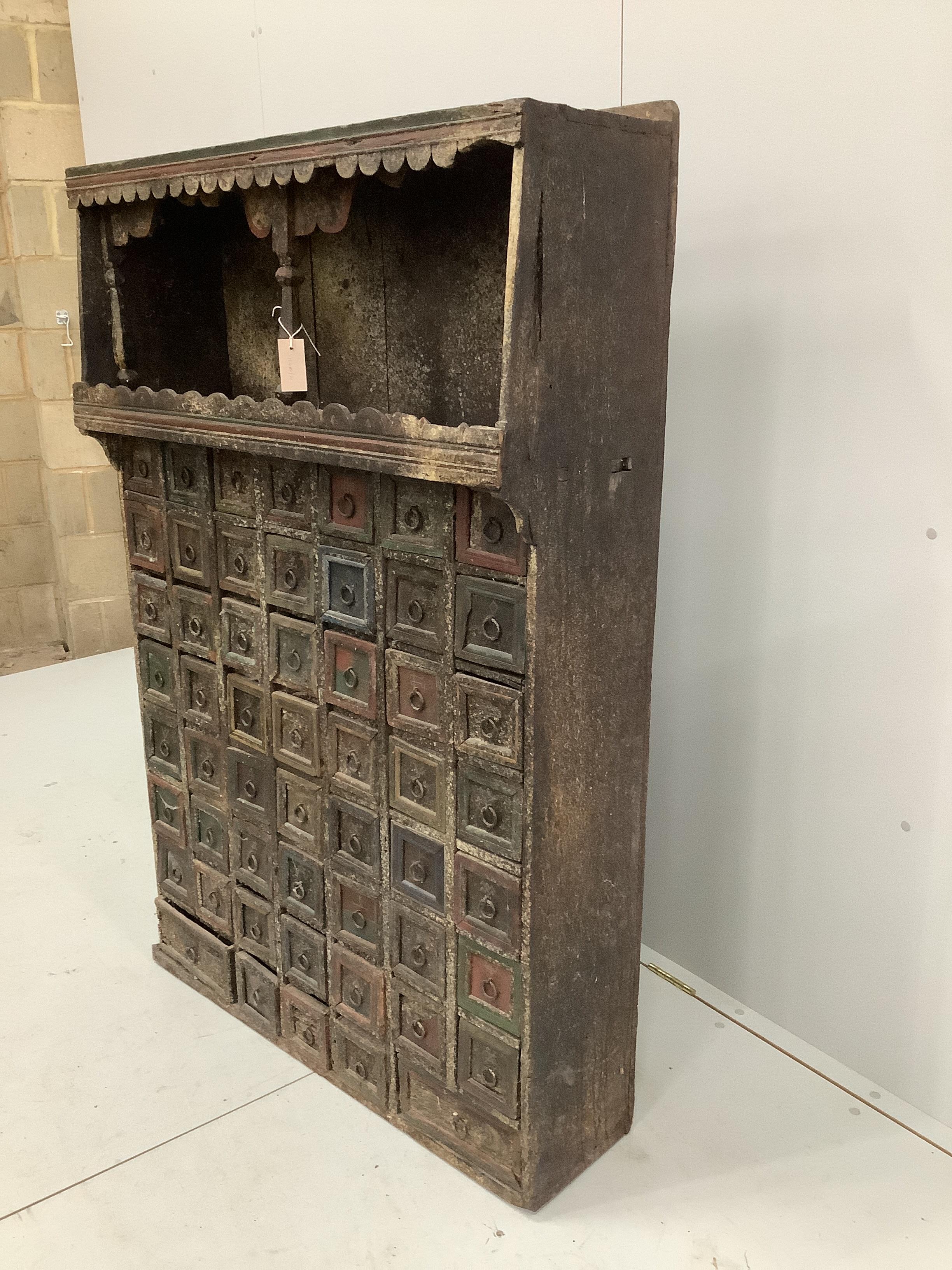 An Indian painted hardwood bank of drawers (af), width 96cm, depth 31cm, height 141cm